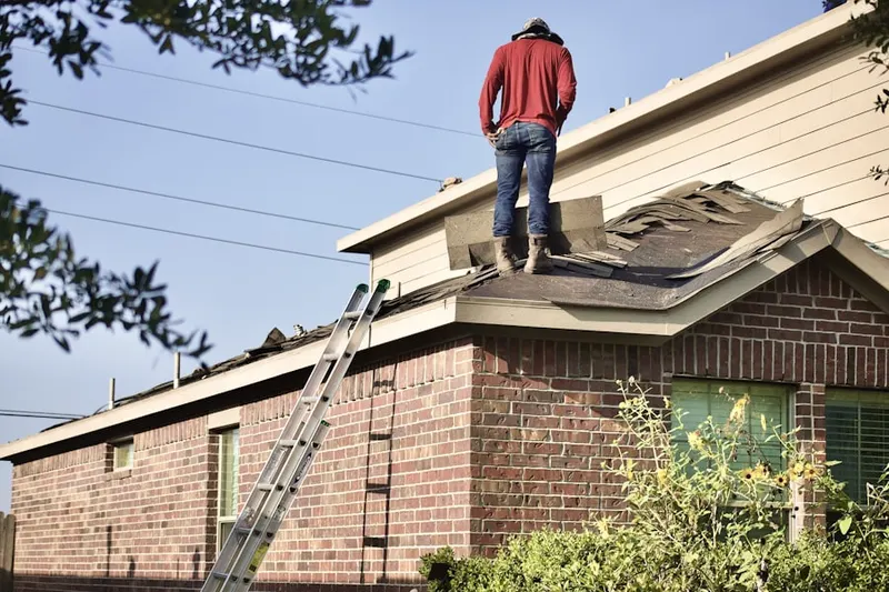 Professional roofer working on a residential roof in Sun Sand